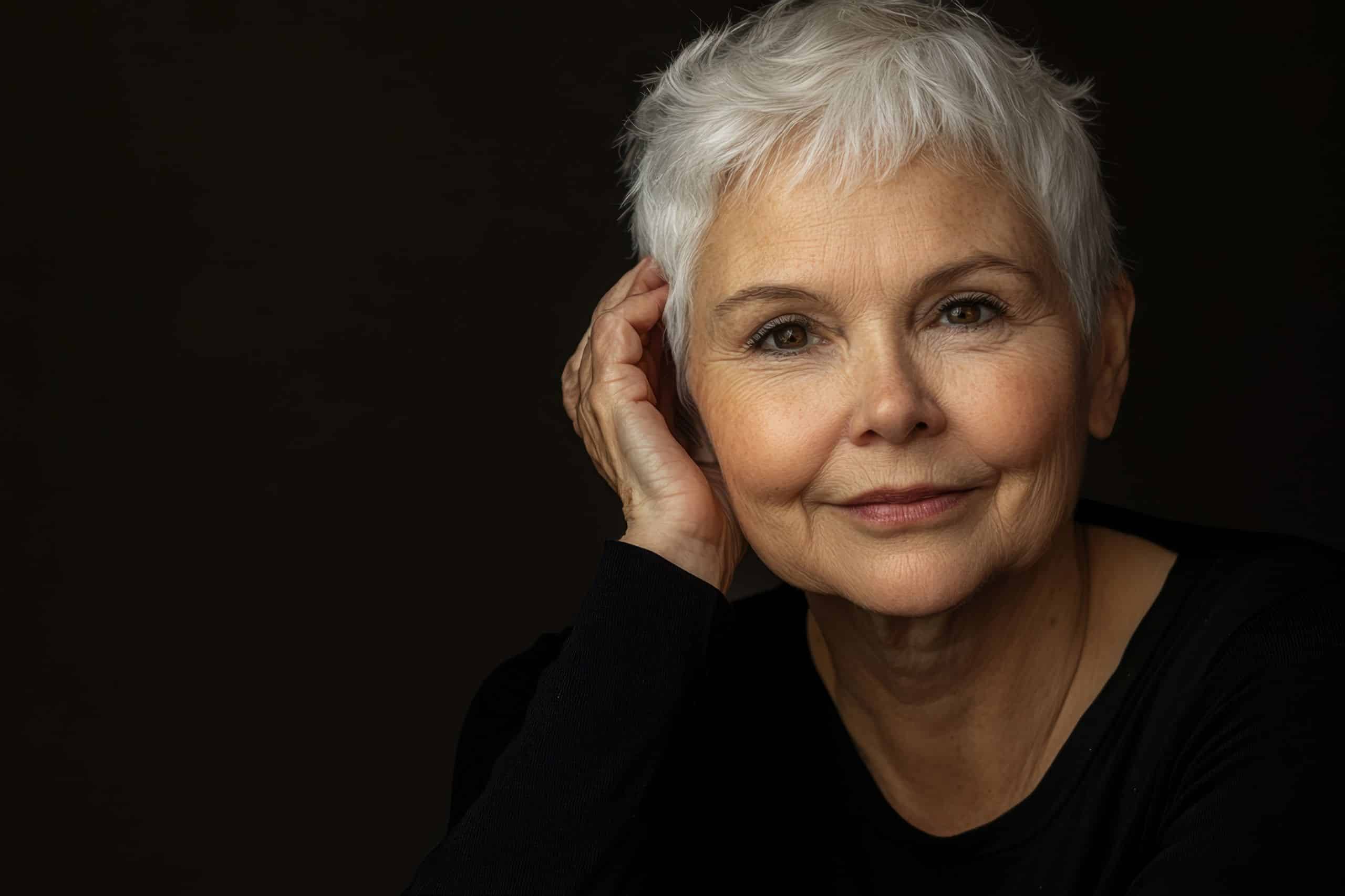 older woman posing with short gray hair after a hair salon appointment